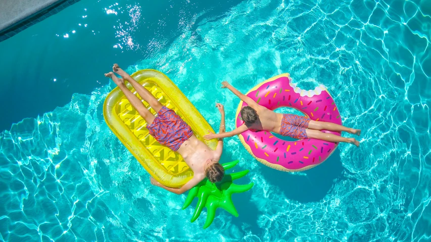 two people floating on inflatable donuts in a pool, pexels contest winner, square, avatar image, very sunny weather, cute boys