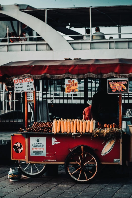 a cart that has some kind of food on it, pexels contest winner, orange and black tones, hotdogs, bangkok, counter