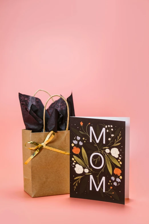 a mother's day card next to a gift bag, by Morgan Russell, uplit, salmon, matte black paper, thumbnail