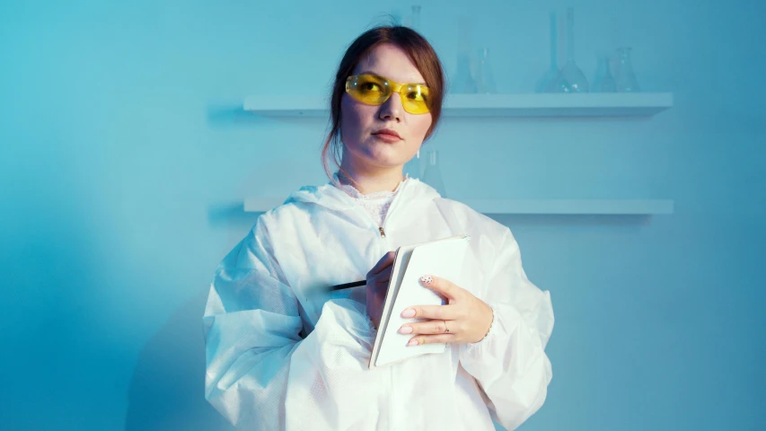 a woman in a lab coat holding a book, inspired by Elsa Bleda, analytical art, yellow sport glasses, avatar image, woman in streetwear, chemical woekshop