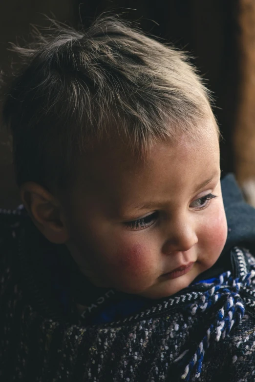 a baby wrapped in a blanket looking out a window, by Nina Hamnett, pexels contest winner, portrait of a rugged warrior, pouty face, boys, over the shoulder closeup