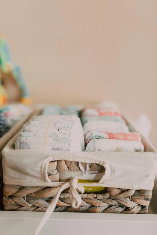 a basket filled with diapers sitting on top of a dresser, by Eden Box, unsplash, organic detail, pouches, zoomed in, multiple stories