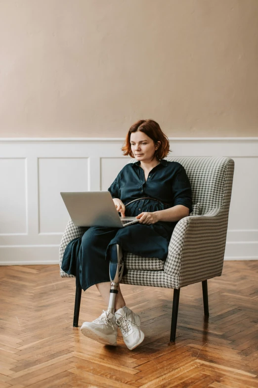 a woman sitting in a chair with a laptop, by Adam Marczyński, pexels contest winner, renaissance, hr ginger, wide full body, nursing, kirsi salonen