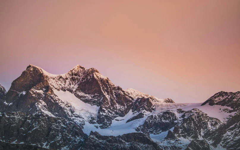 the mountains are covered in snow at sunset, an album cover, by Peter Churcher, unsplash contest winner, 4 k hd wallpapear, brown, chamonix, pink skies