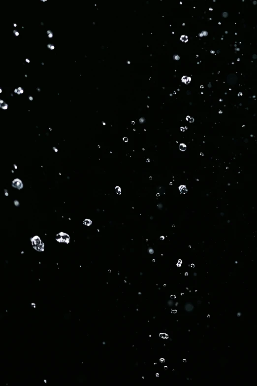 a close up of water bubbles on a black background, an album cover, inspired by Vija Celmins, unsplash, conceptual art, diamonds, low quality footage, ☁🌪🌙👩🏾, hq 8k cinematic