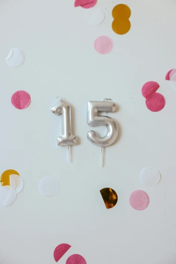 a close up of a birthday cake with balloons and confetti, by Nicolette Macnamara, trending on unsplash, silver，ivory, fifteen-dimensional, golden number, emma bridgewater and paperchase