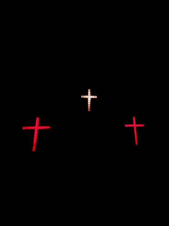 three crosses are lit up in the dark, an album cover, by Attila Meszlenyi, unsplash, red and white neon, fuji x 1 0 0 f, sao paulo, # 0 1 7 9 6 f