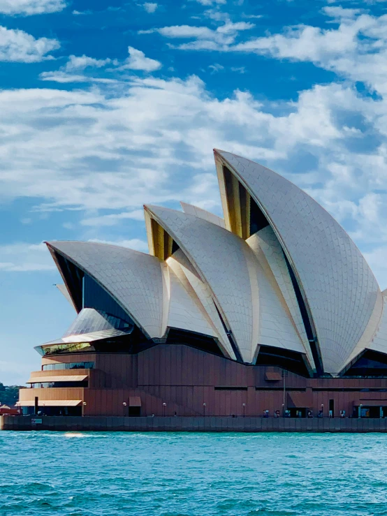 a large building sitting on top of a body of water, inspired by Sydney Carline, pexels contest winner, modernism, singing at a opera house, profile image, golden windows, geodesic architecture