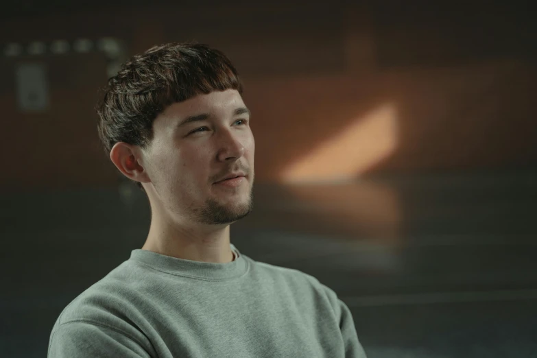 a close up of a person wearing a sweater, a character portrait, by Thomas Furlong, unsplash, hyperrealism, calmly conversing 8k, stood in a lab, greig fraser cinematography, a young man