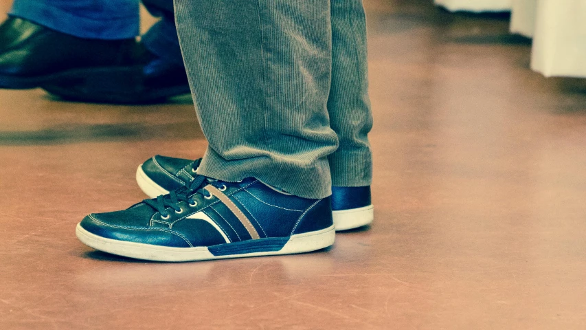 a close up of a person wearing a pair of shoes, by Adam Marczyński, at a mall, family friendly, older male, stylized photo