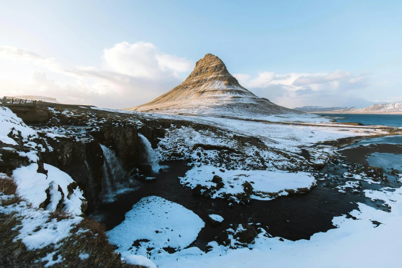 a mountain covered in snow next to a body of water, pexels contest winner, icelandic valley, thumbnail, stacked image, medium format
