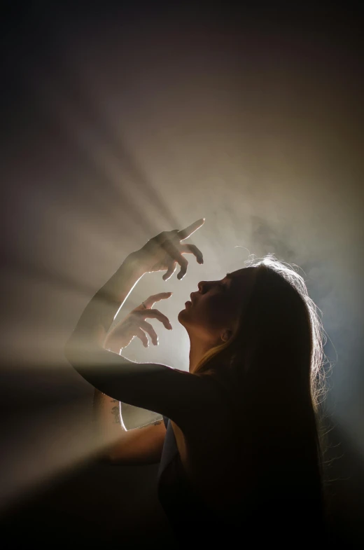 a woman that is standing in the dark, pexels contest winner, light and space, casting an evil spell, sunlight filtering through skin, dark dance photography aesthetic, pointing to heaven