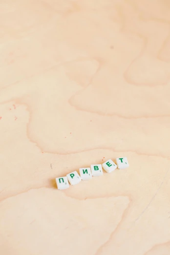 a couple of dicers sitting on top of a wooden table, by andrei riabovitchev, unsplash, green letters, lorem ipsum dolor sit amet, 000 — википедия, ussr