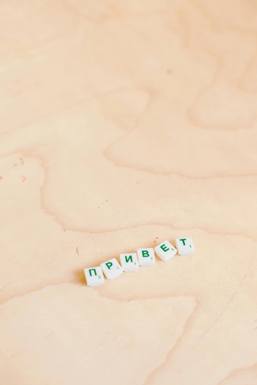 a couple of dicers sitting on top of a wooden table, by andrei riabovitchev, unsplash, green letters, lorem ipsum dolor sit amet, 000 — википедия, ussr