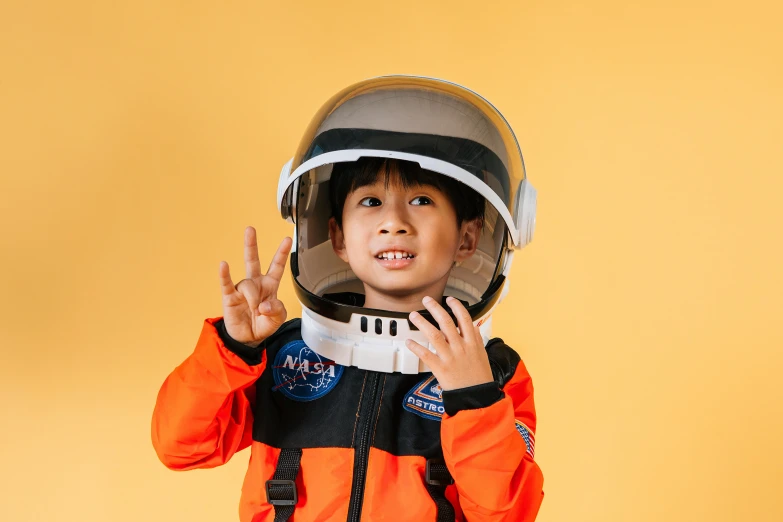 a little boy in a space suit making a peace sign, pexels contest winner, asian human, a handsome, 🦩🪐🐞👩🏻🦳, avatar image