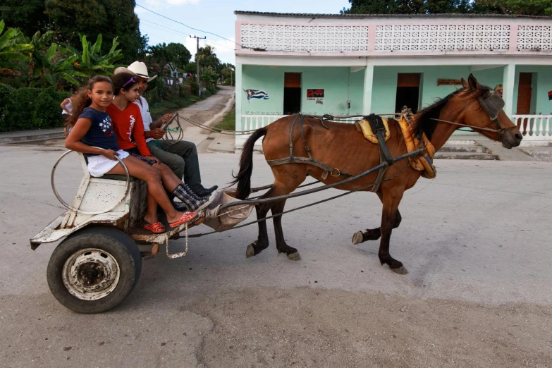 a couple of people riding on the back of a horse drawn carriage, 30-year-old woman from cuba, avatar image