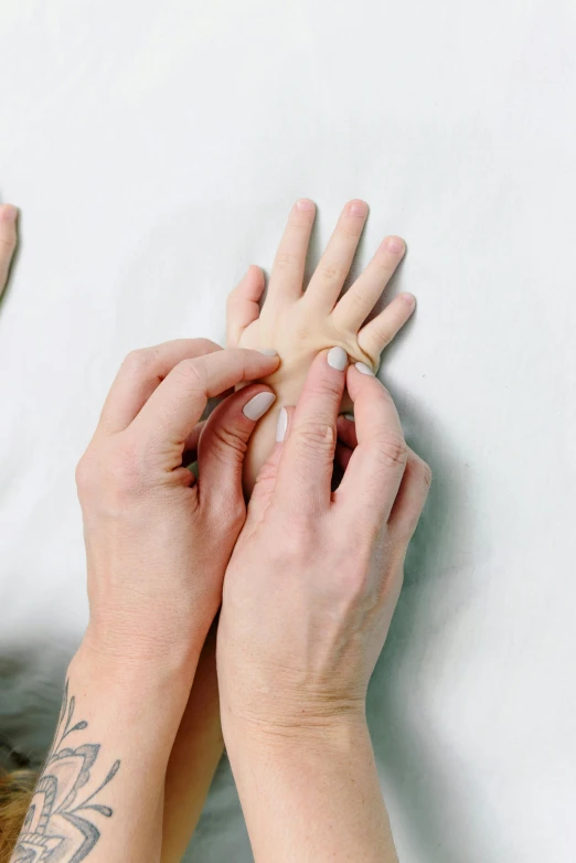 a woman laying in bed with her hands on a pillow, process art, silicone skin, single pair of hands, instruction, clinical