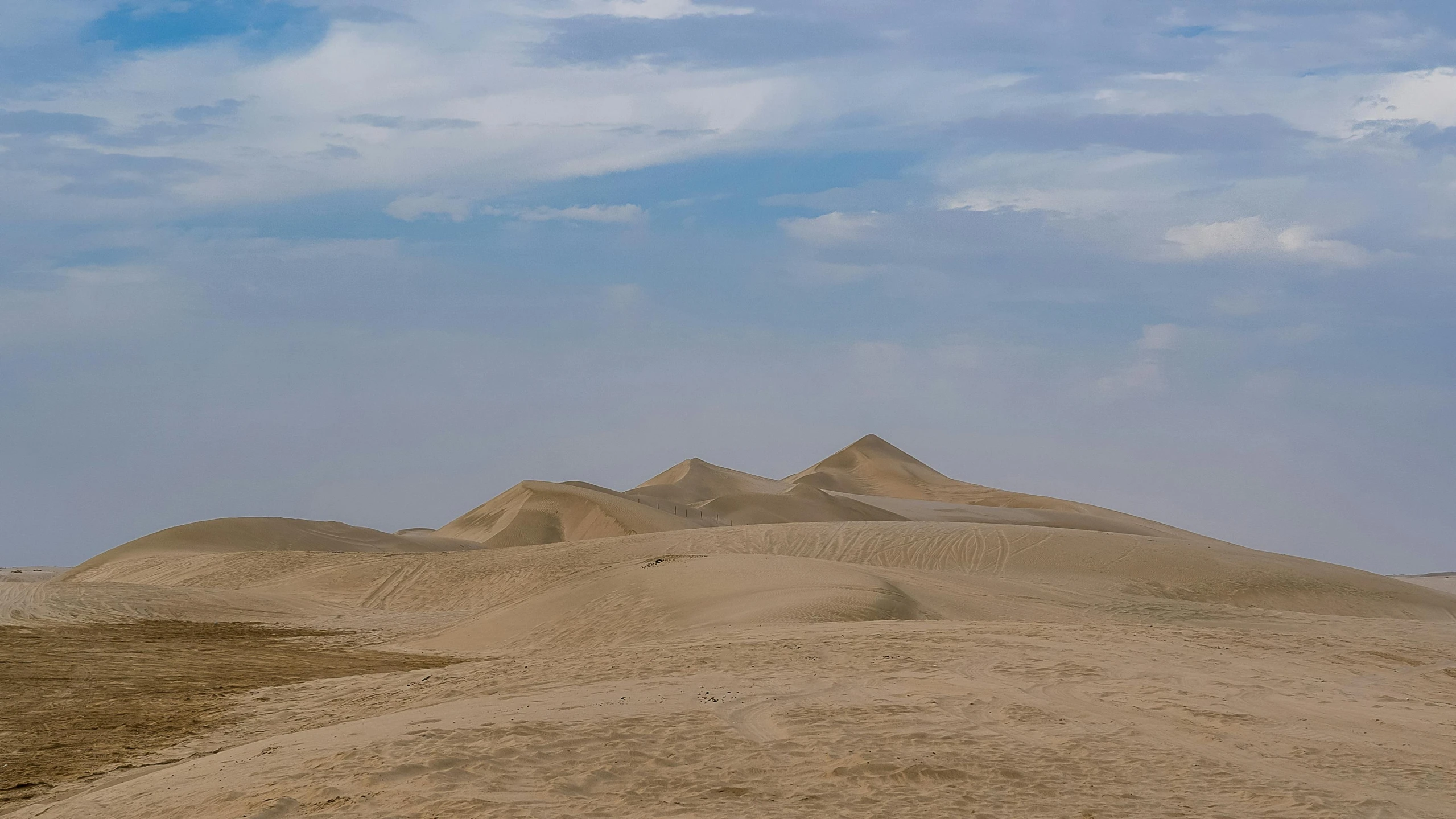 a person riding a horse in the desert, pexels contest winner, land art, background image, mesopotamic, panoramic, dunes