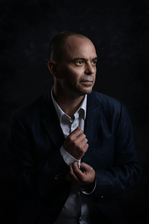 a man in a suit adjusting his tie, an album cover, inspired by Richard Wright, pexels contest winner, photorealism, posing in dramatic lighting, peter paul rebens, mid length portrait photograph, portrait photograph