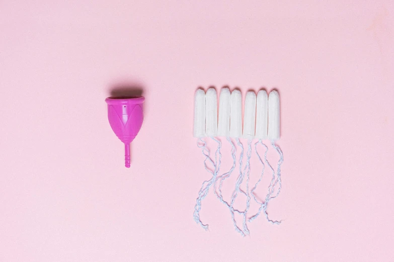a bunch of toothbrushes sitting on top of a pink surface, by Nicolette Macnamara, plasticien, membrane pregnancy sac, alien capsules, tassels, femme fetal