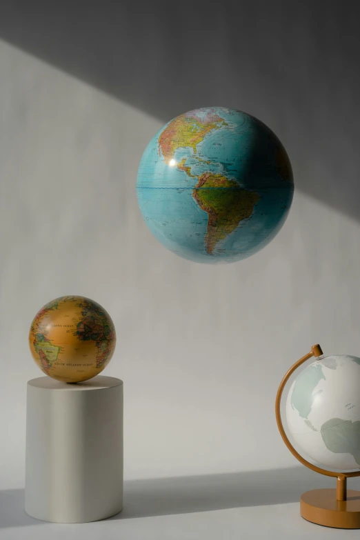 a group of three globes sitting next to each other, curated collection, floating world, modeled, overhead