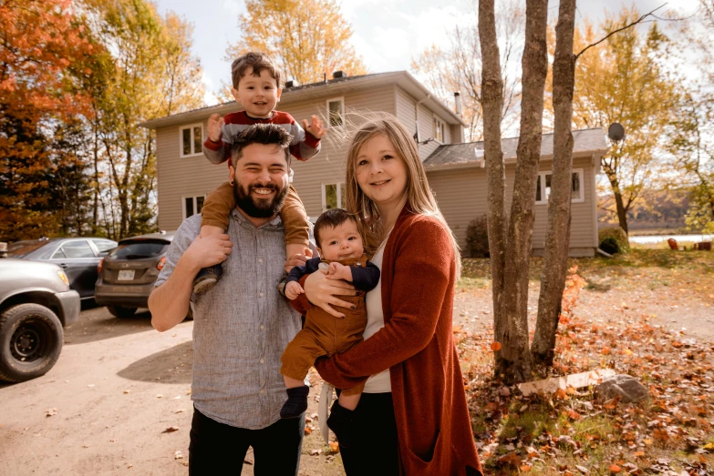 a family standing in front of a house in the fall, a portrait, by Kristin Nelson, pexels, gauthier leblanc, avatar image, maintenance photo, husband wife and son