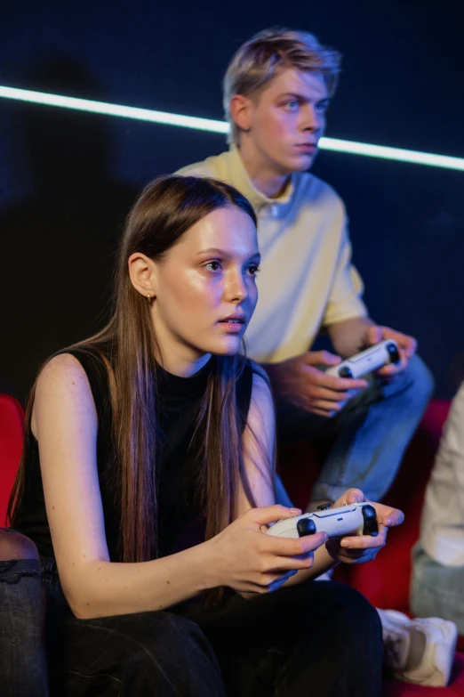 a group of people sitting on top of a red couch, holding controller, she has a distant expression, young teen, trending arstationhq