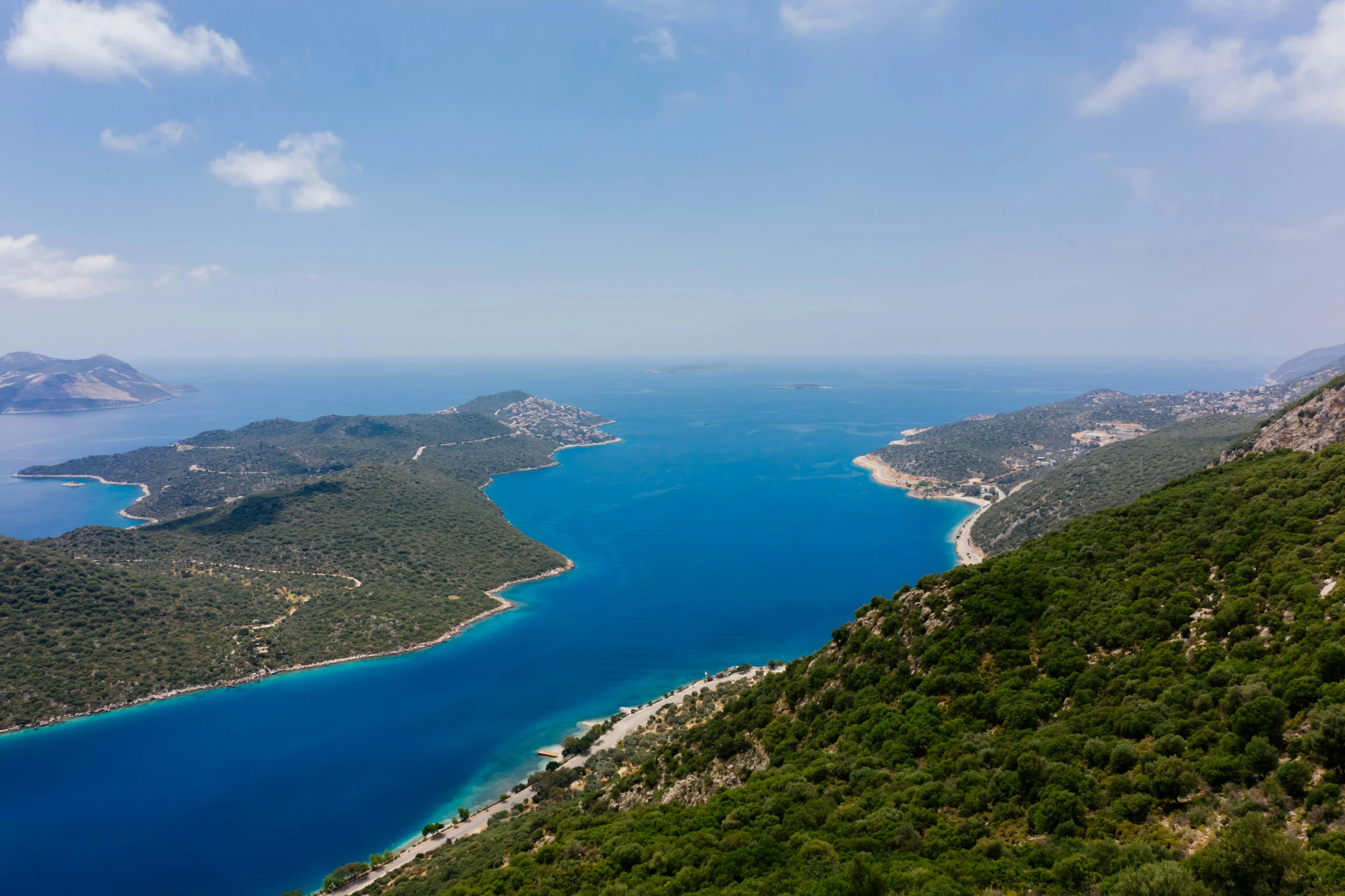 a large body of water sitting on top of a lush green hillside, by Matthias Stom, pexels contest winner, hurufiyya, blue sea, turkey, high quality product image”, multiple stories