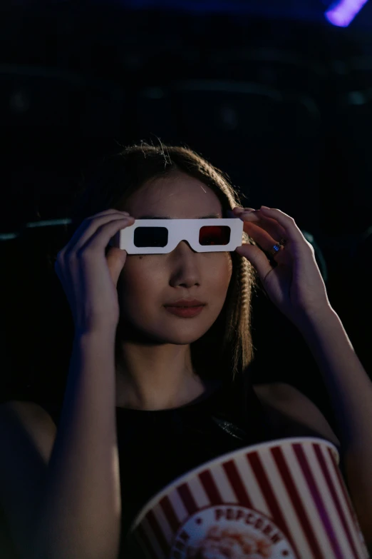 a woman in a movie theater wearing 3d glasses, inspired by Zhu Da, trending on unsplash, holography, star trek asian woman, portrait of kim petras, siggraph, during an eclipse