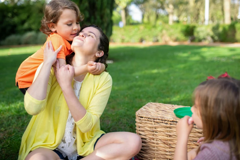 a woman and a little girl sitting on the grass, woman holding another woman, eating outside, casual playrix games, mummy