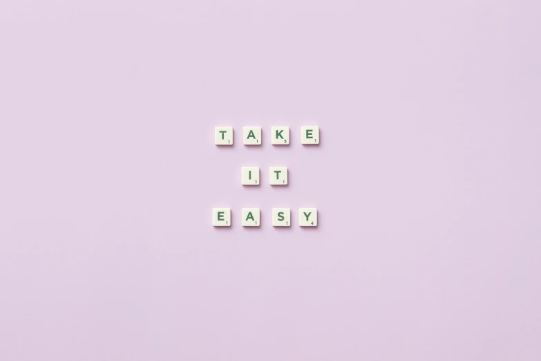 the words take it easy spelled in scrabbles on a pink background, by Emma Andijewska, trending on pexels, light purple, clemens ascher, purple and green colors, set on singaporean aesthetic