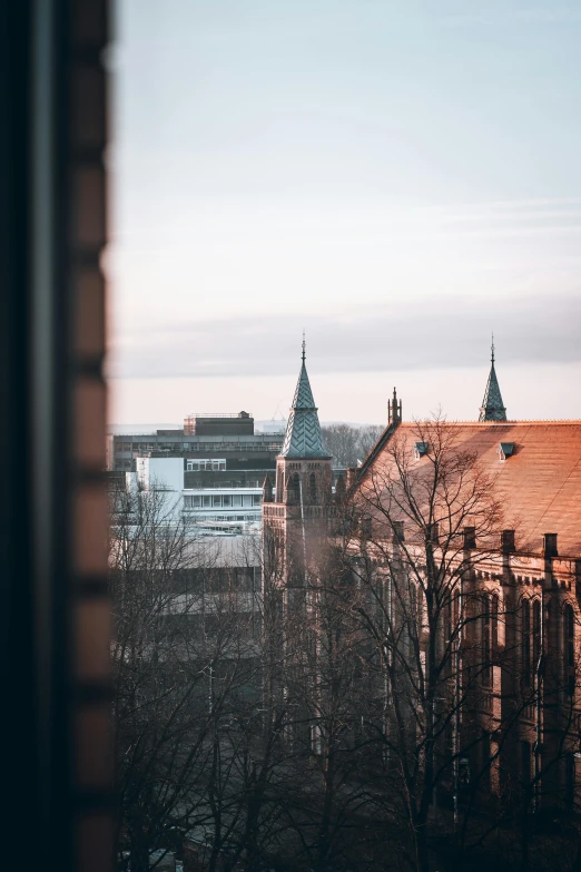 a view of a city from a window, hannover, 2019 trending photo, college, golden hour cinematic