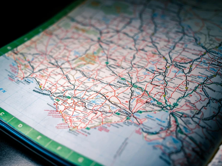 a close up of a map on a table, by Lee Loughridge, unsplash, road trip, detailed color scan”, backlit, “the ultimate gigachad