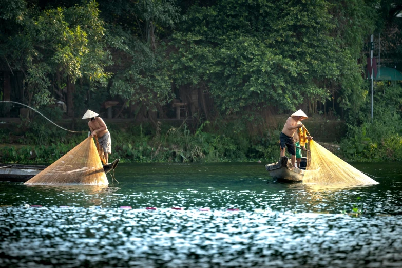 a couple of people that are in some water, inspired by Steve McCurry, pexels contest winner, fishing village, avatar image, gardening, vietnam war