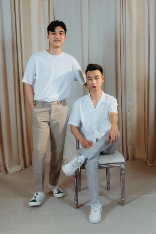 a couple of men sitting on top of a chair, inspired by Wang Duo, instagram, dau-al-set, wearing a light shirt, non binary model, wearing pants and a t-shirt, bian luan