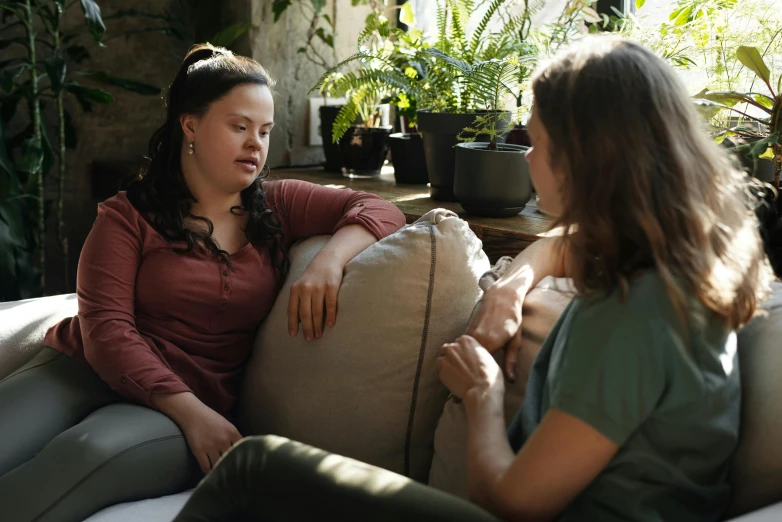 a couple of women sitting on top of a couch, trending on pexels, empathic, low quality photo, plus-sized, teenager girl