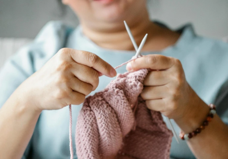 a woman knitting a pink sweater with a pair of scissors, trending on pexels, royal commission, thumbnail, 1 2 9 7, digital image