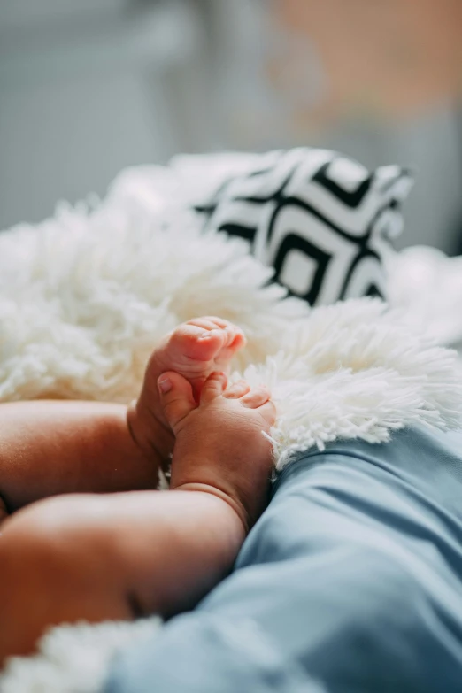 a close up of a baby's feet on a bed, by Carey Morris, pexels, cuddly fur, gif, vibrant realistic, breeding