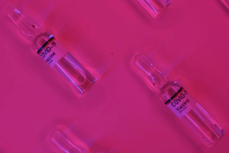 a group of vials sitting on top of a pink surface, thumbnail, neons, syringe, feature