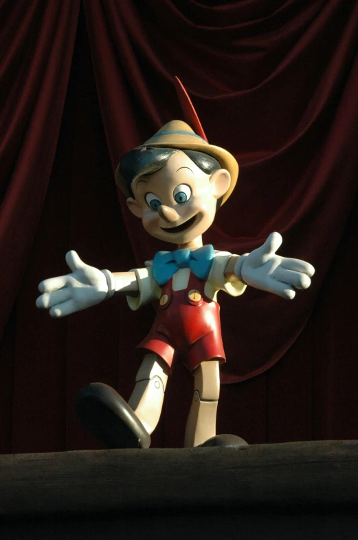 a statue of a clown standing on a stage, a cartoon, inspired by Luigi Kasimir, pinocchio, disney studios, ‘luca’, slide show
