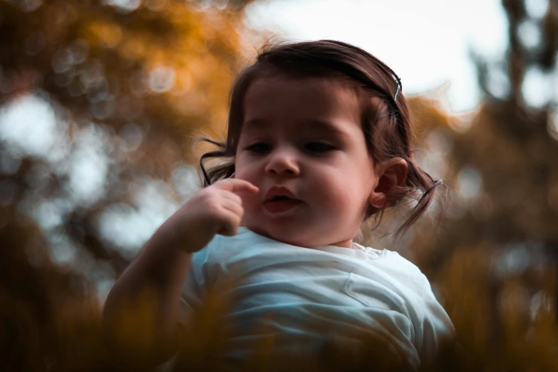 a little girl with a tooth brush in her mouth, by irakli nadar, pexels contest winner, symbolism, amongst foliage, 2 years old, backlit ears, pointing at the camera