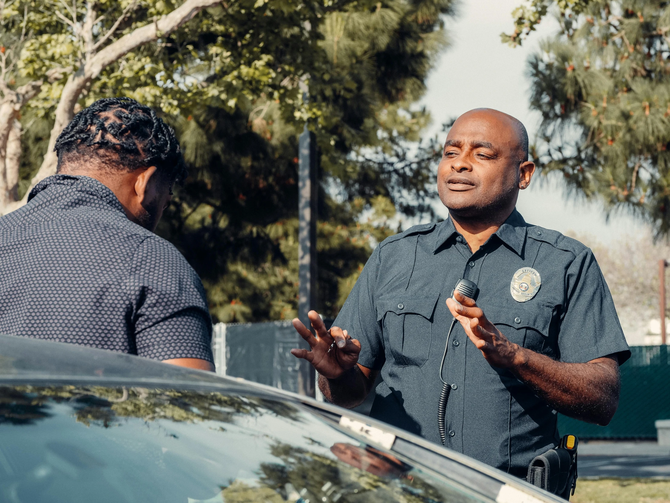 a man in a police uniform talking to another man, unsplash, los angelos, essence, fan favorite, nearest neighbor