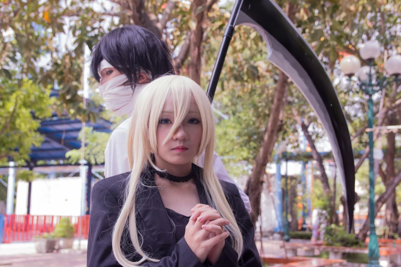 a woman standing next to a man holding a scythe, by Ei-Q, anime cosplay, misa amane *, square, taken in 2 0 2 0