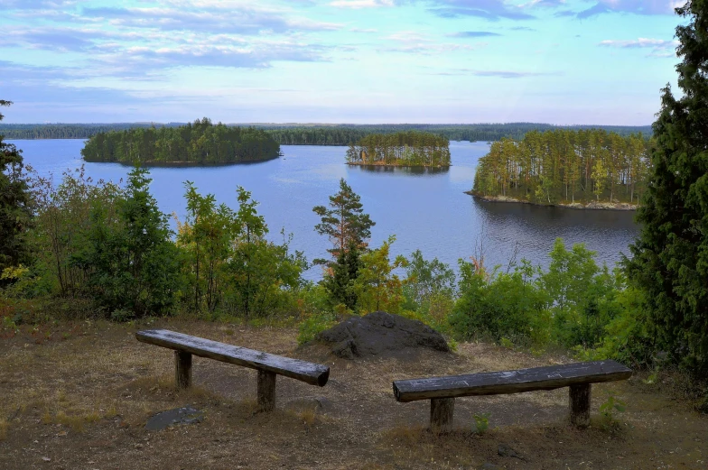 a couple of benches sitting on top of a hill, a picture, by Eero Järnefelt, pexels contest winner, hurufiyya, two medium sized islands, forest with lake, slide show, three views