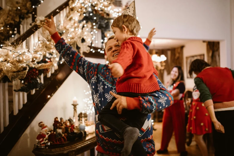 a man carrying a child up a flight of stairs, pexels contest winner, happening, wearing festive clothing, avatar image, joyful people in the house, boys