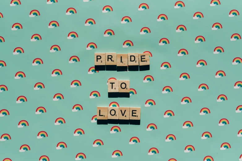 wooden blocks spelling pride to love with a rainbow in the background, by Julia Pishtar, trending on pexels, graffiti, 1 6 x 1 6, teal paper, background image, adrian tomine