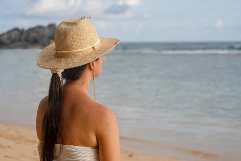 a woman standing on top of a sandy beach, white straw flat brimmed hat, gazing off into the horizon, profile image, samoan features