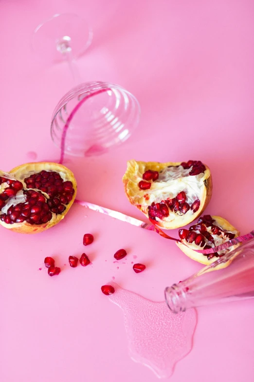 two halves of pomegranate on a pink surface, a still life, by Lucette Barker, pexels, bubbly, pastries, battle toast, do