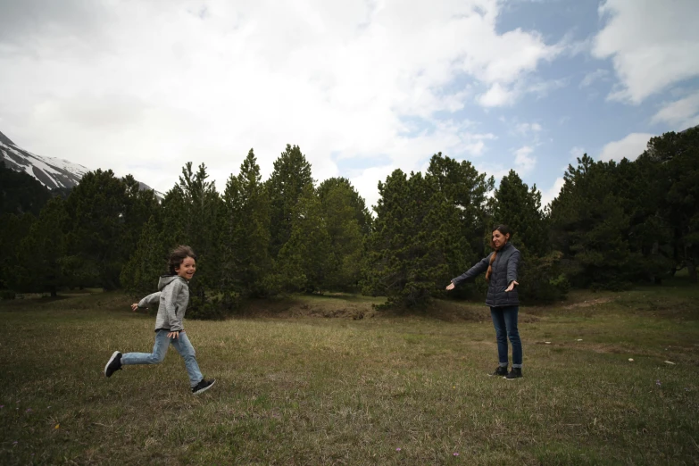 two people are playing frisbee in a field, les nabis, pine forests, jaime jasso, childhood, portait image