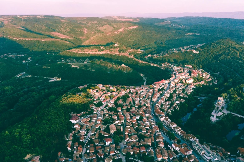 an aerial view of a small town in the mountains, pexels contest winner, renaissance, bosnian, maroon, gopro photo, soft lighting from above